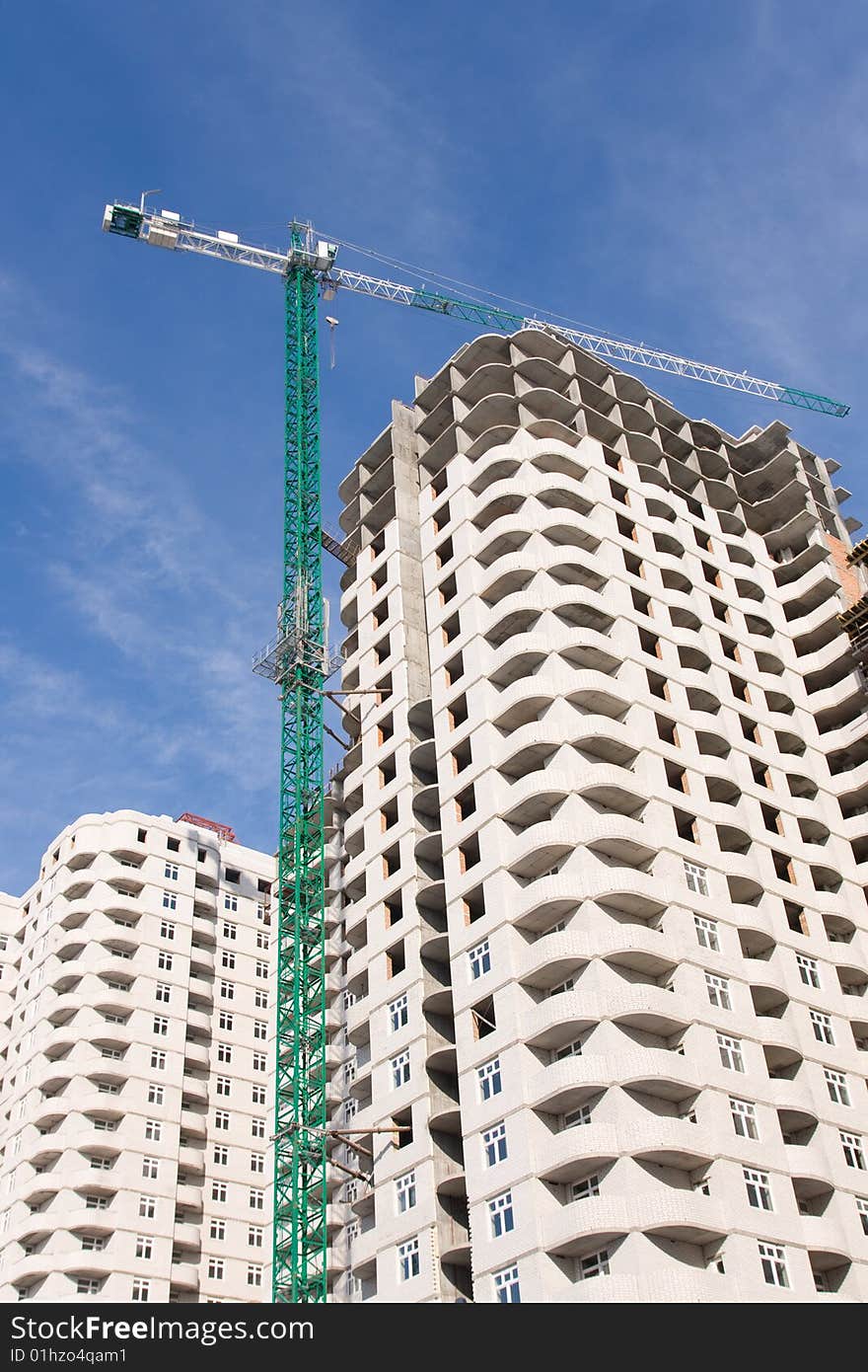 Crane and building construction on a background sky