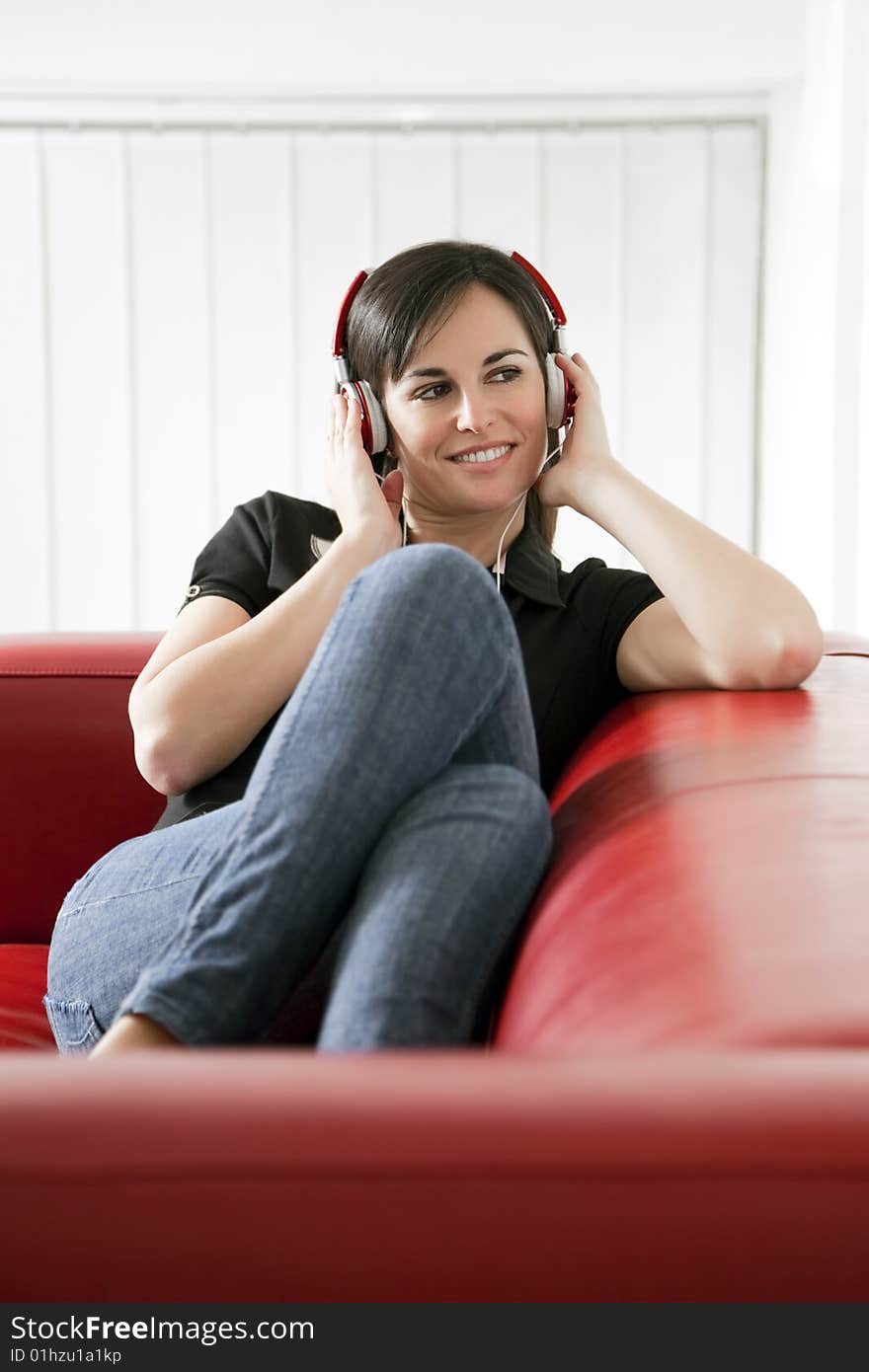 Mid adult woman listening to music at home. Copy space