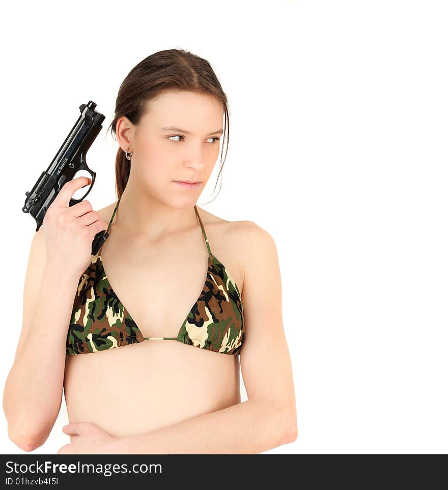 Beautiful female with gun and camouflaged swimsuit looks dangerously - with copy space. Beautiful female with gun and camouflaged swimsuit looks dangerously - with copy space