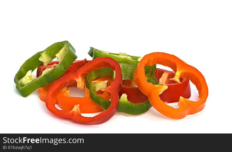 Longitudinal sections of green, yellow and red sweet peppers isolated on white background. Longitudinal sections of green, yellow and red sweet peppers isolated on white background