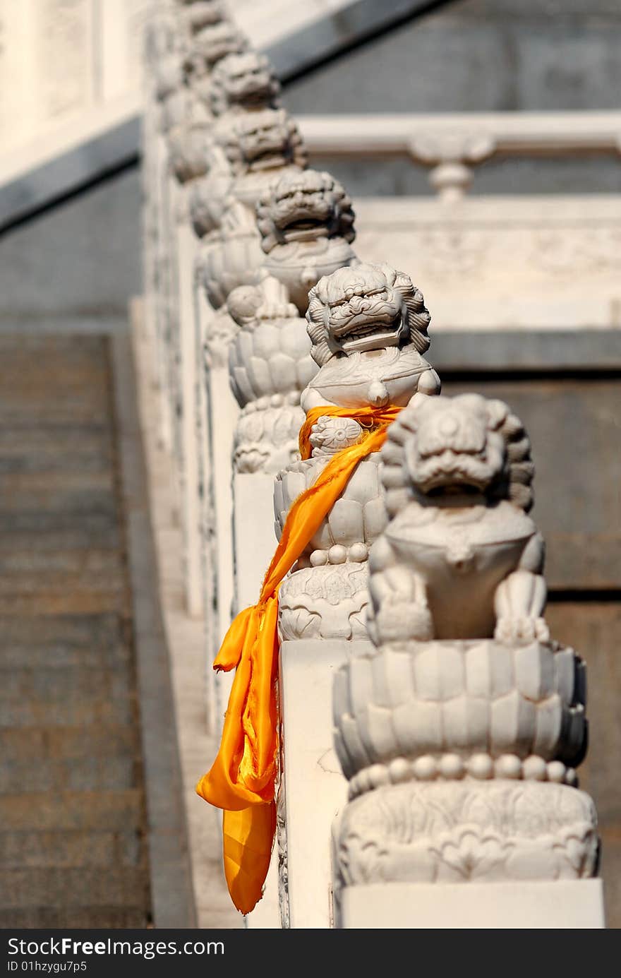 One of stone lions, which stand the side of stair to the temple, was tied a orange Hada, a silk band which symbols happiness and luck in Buddhism. One of stone lions, which stand the side of stair to the temple, was tied a orange Hada, a silk band which symbols happiness and luck in Buddhism.