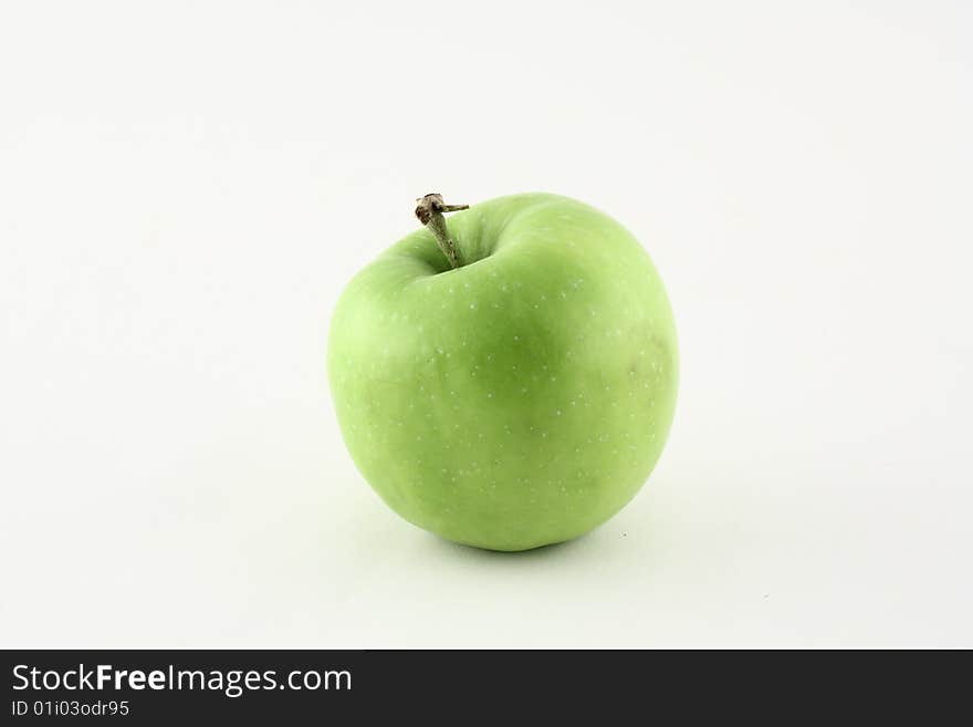 A fresh green apple on a white background. A fresh green apple on a white background