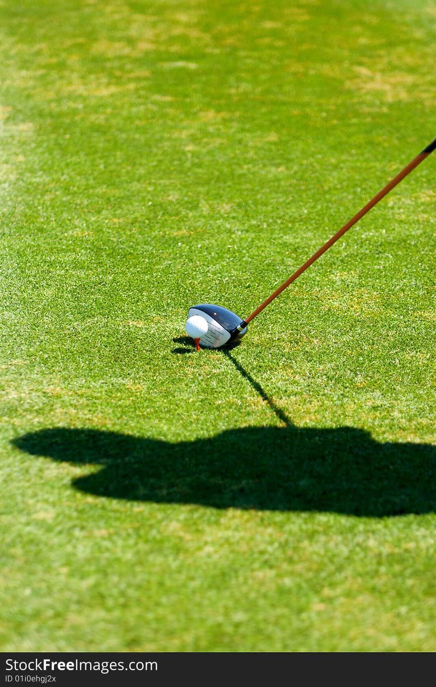 An image of a golfer's shadow while preparing to put