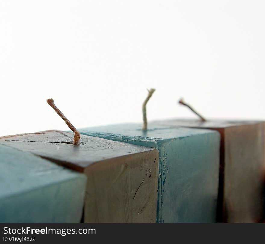 Colored candles in line with the isolated white background