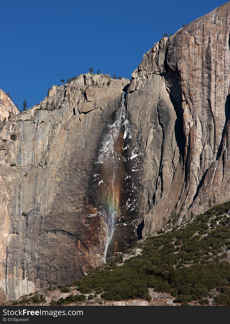 Yosemite waterfall in the early morning light with a rainbow effect, California (USA). Yosemite waterfall in the early morning light with a rainbow effect, California (USA)