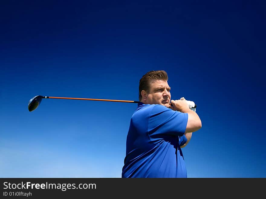 An image of a man swinging a golf club after putting. An image of a man swinging a golf club after putting