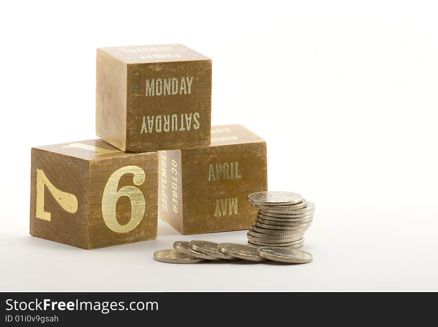 Date blocks showing the start of the tax year 2009 with a pile of coins. Date blocks showing the start of the tax year 2009 with a pile of coins