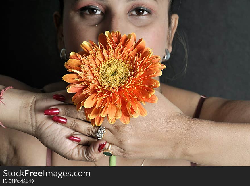 Girl with flower in studio.