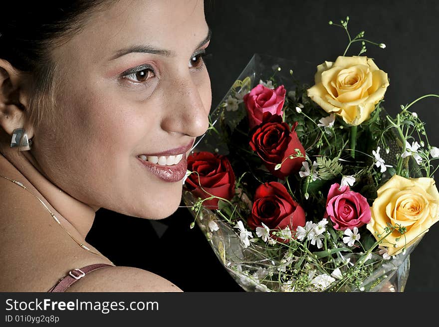 Indian girl model holding a bunch of flowers. Indian girl model holding a bunch of flowers.