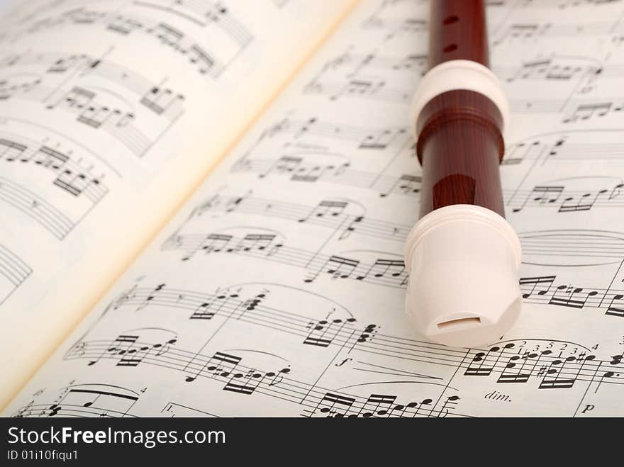 Flute on musical sheet close-up with copy space