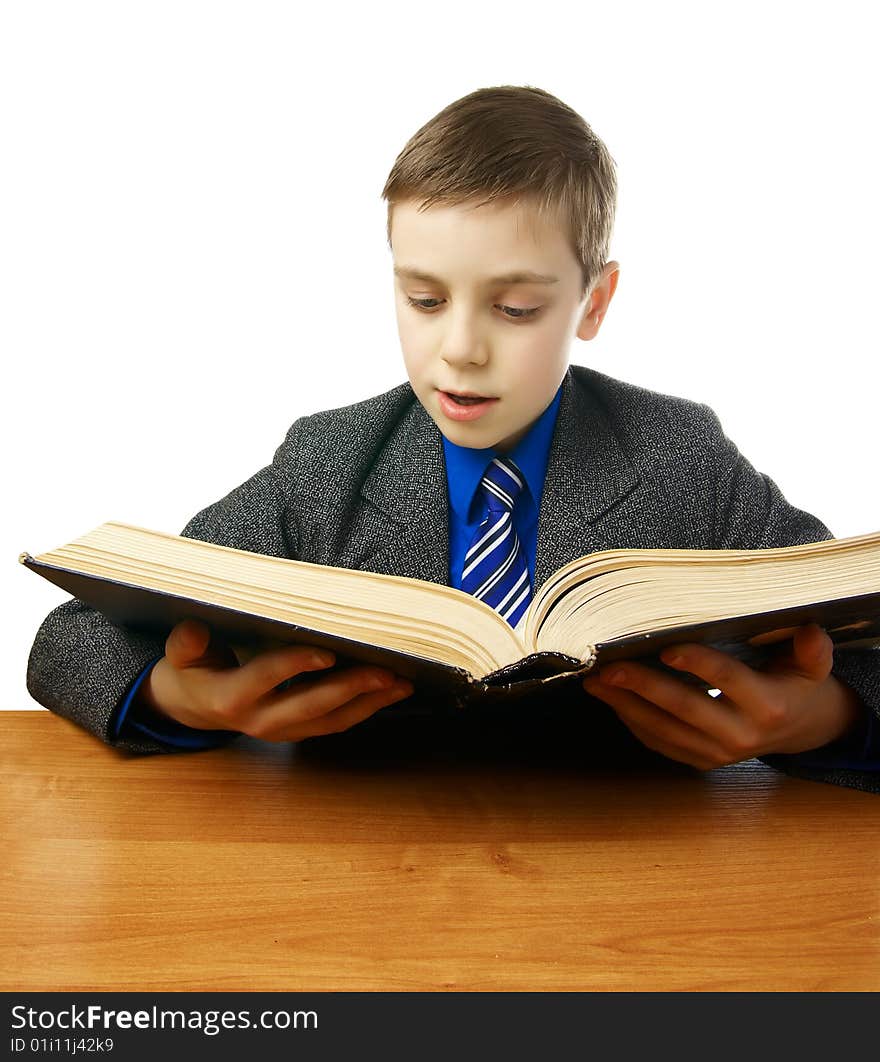 Schoolboy in a gray coat with a blue tie with an old book