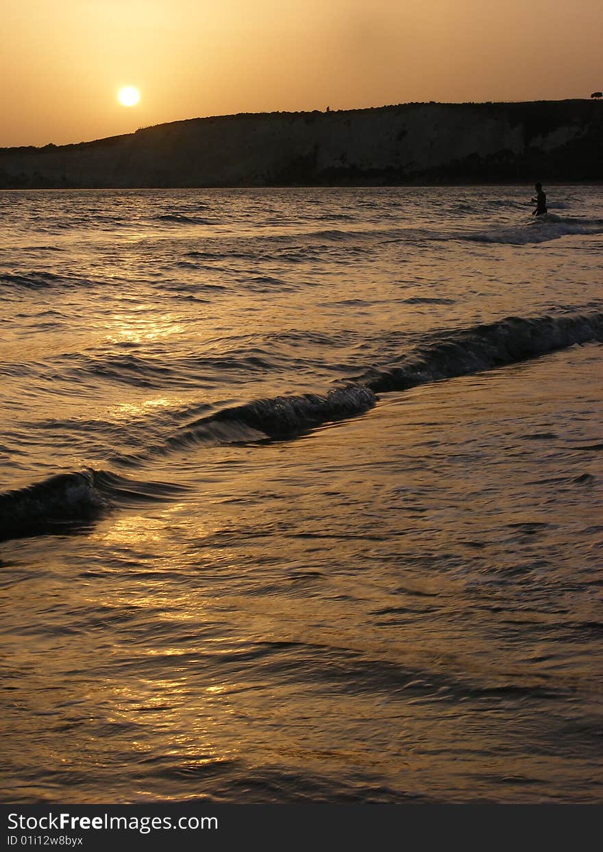 Man taking a last bath at sunset. Man taking a last bath at sunset