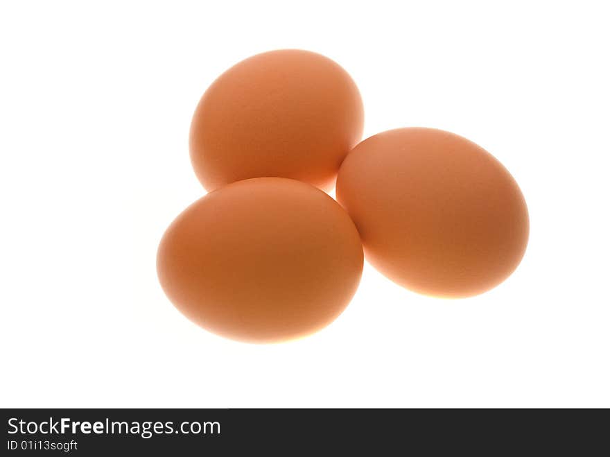 Group of 3 hen's eggs on white shot on light table. Group of 3 hen's eggs on white shot on light table.