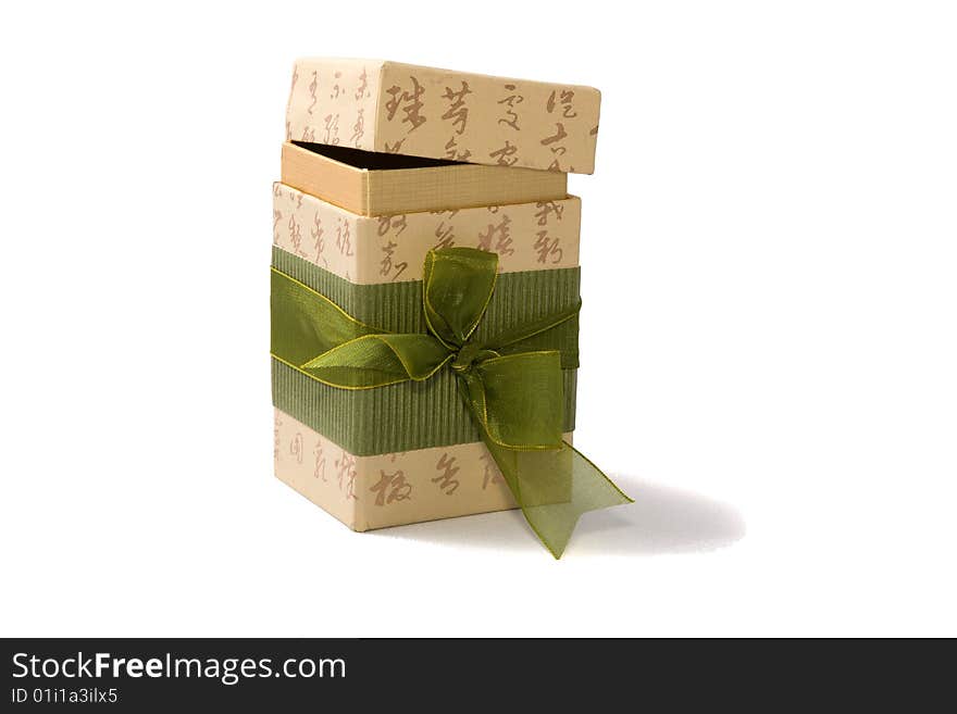 Gift box in asian style with hieroglyphs and green ribbon. Isolatet on white. Path included.