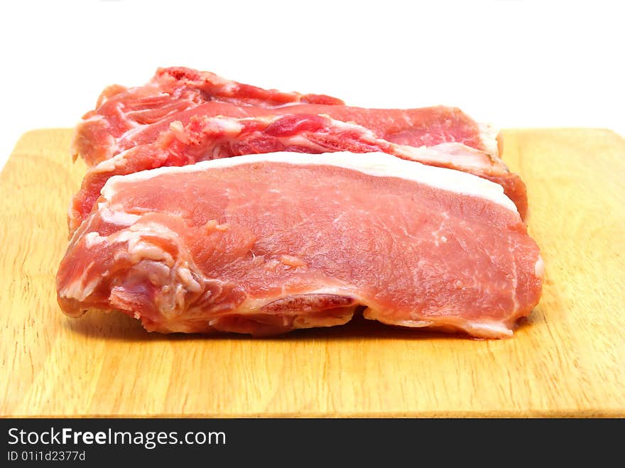 Pieces of crude pork. White background.