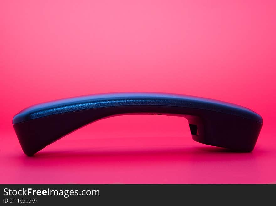 Phone handset isolated on pink background. Phone handset isolated on pink background