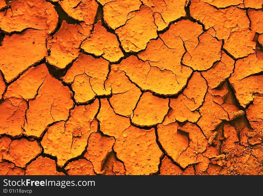 This image captures the intricate patterns of cracked earth, painted in a vibrant orange hue that suggests a scorching climate. Each crack forms a distinct pattern, reminiscent of parched landscapes where water is a scarce resource. The close-up perspective emphasizes the depth and severity of the cracks, offering a detailed glimpse into the texture of dry soil. This type of terrain is commonly seen in arid or semi-arid regions, highlighting environmental issues like drought and desertification. This image captures the intricate patterns of cracked earth, painted in a vibrant orange hue that suggests a scorching climate. Each crack forms a distinct pattern, reminiscent of parched landscapes where water is a scarce resource. The close-up perspective emphasizes the depth and severity of the cracks, offering a detailed glimpse into the texture of dry soil. This type of terrain is commonly seen in arid or semi-arid regions, highlighting environmental issues like drought and desertification.