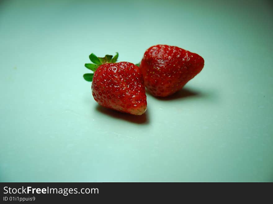 Two strawberrys on a table