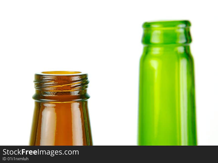 Empty beer bottles isolated against a white background