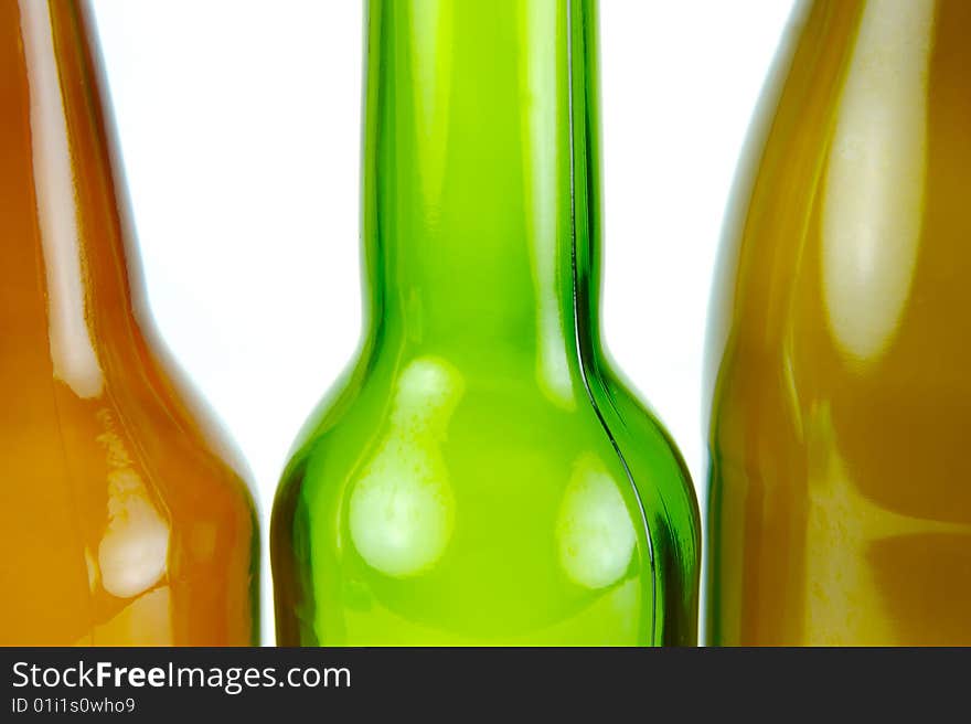 Empty beer bottles isolated against a white background