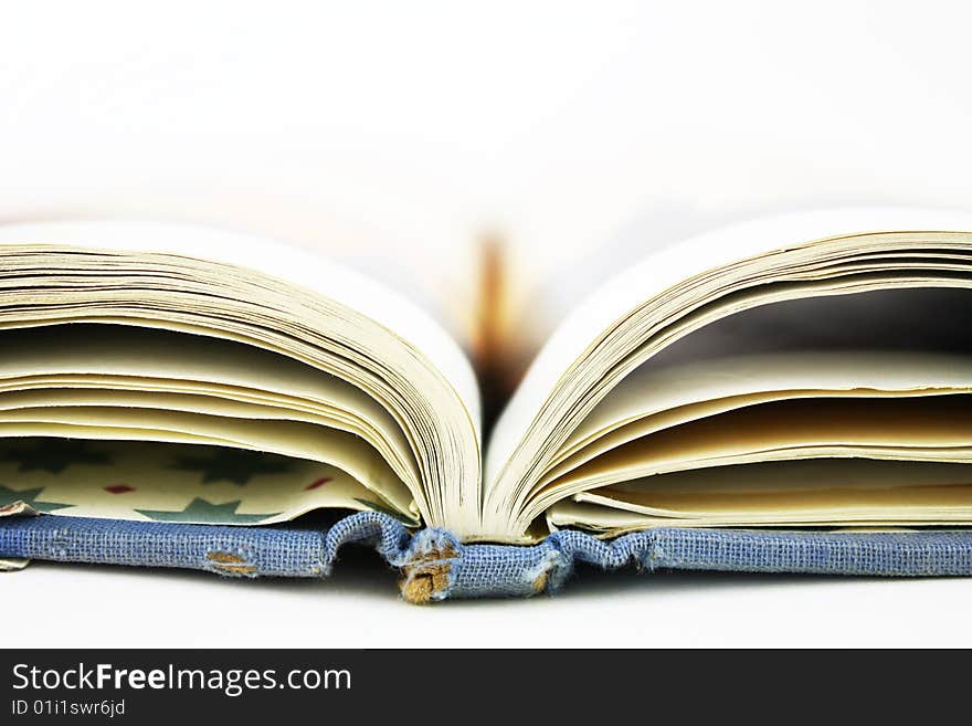 An old opened book isolated on white background