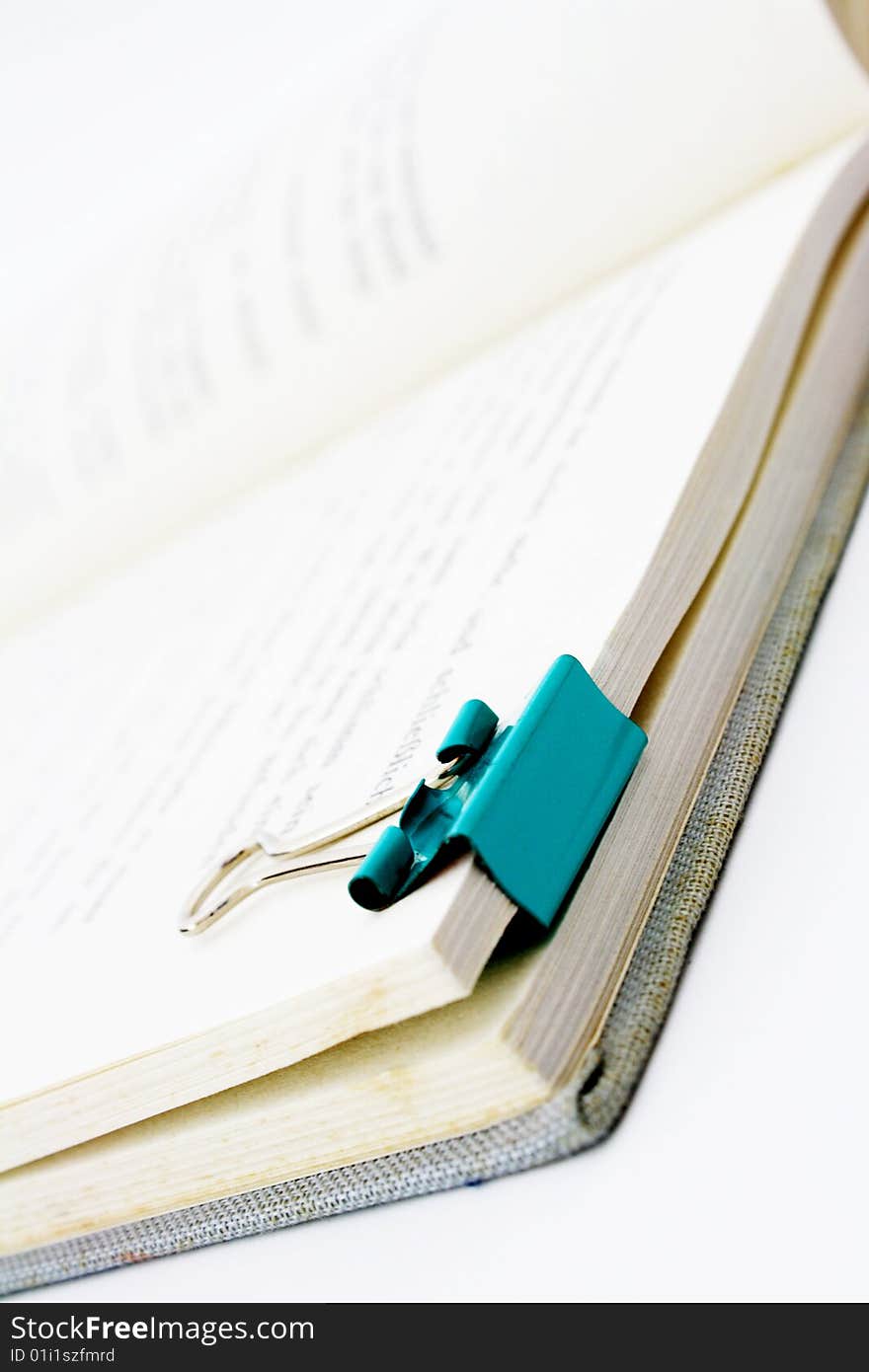 Book with paper clip isolated on white background. Book with paper clip isolated on white background