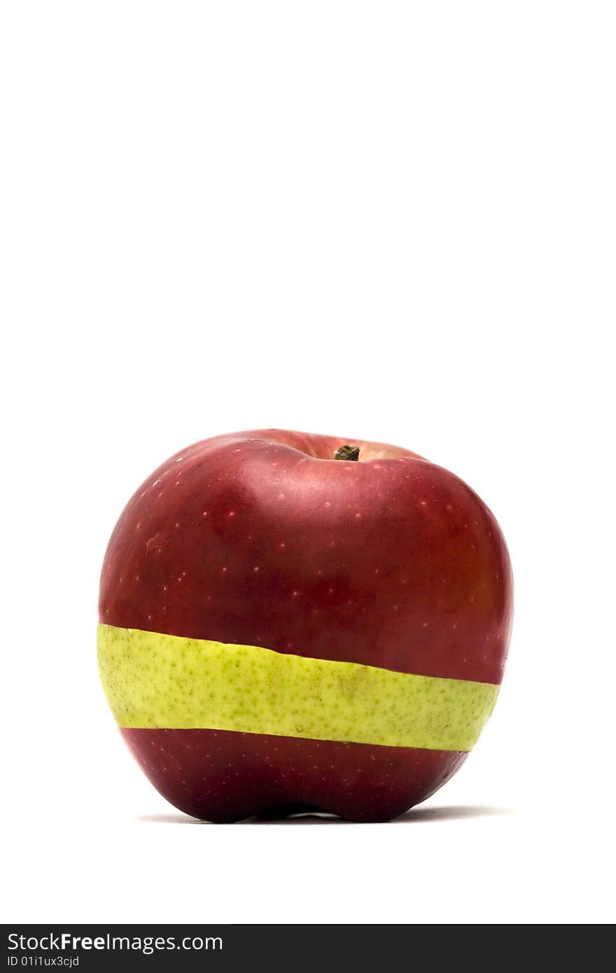 A red apple, with a green slice in between. A red apple, with a green slice in between.