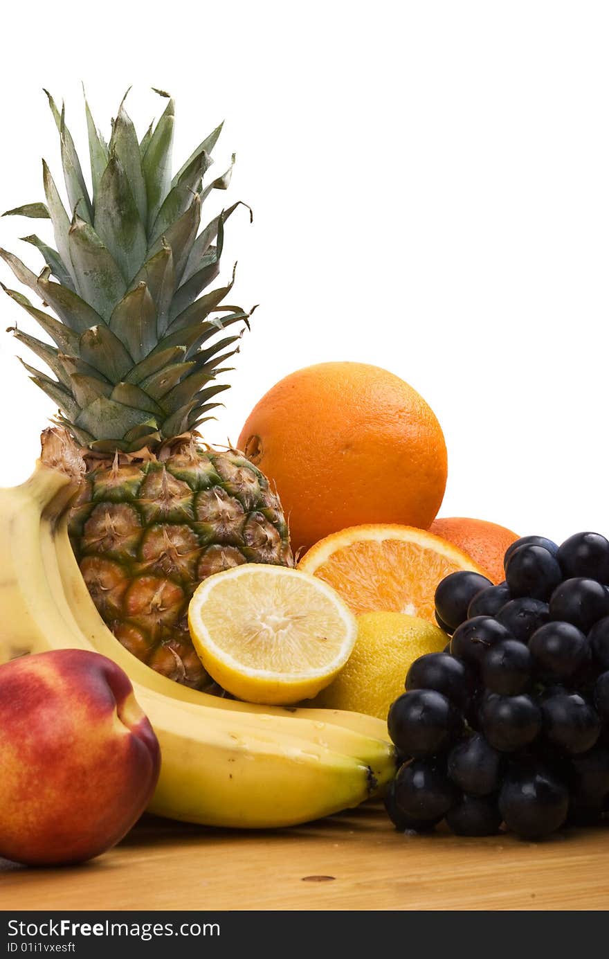 Close up of fresh fruits, whole and sliced fruit on wood table.Check out also Healthy food