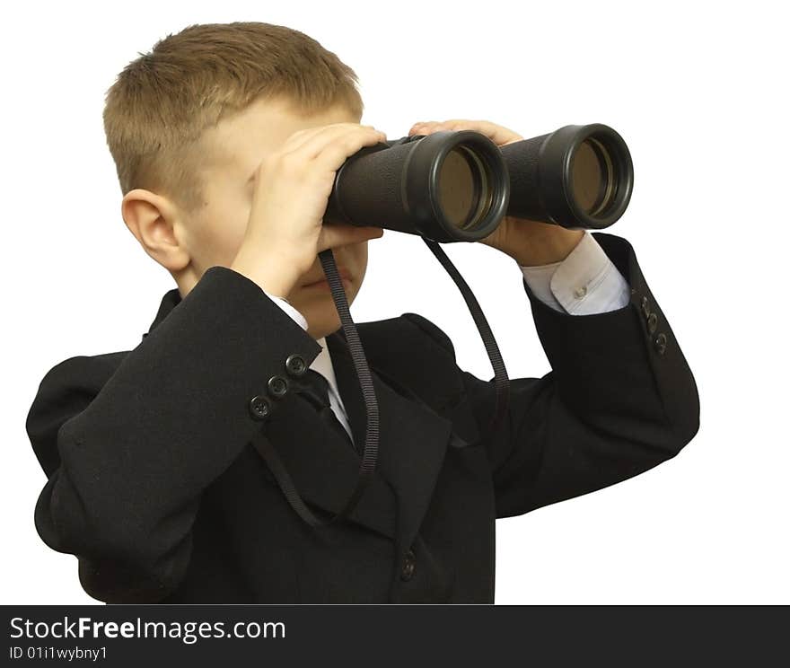 Child in a business suit with the field-glass isolated on white