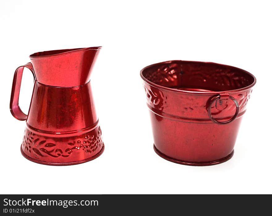 Two miniature red metal buckets on white background. Two miniature red metal buckets on white background.