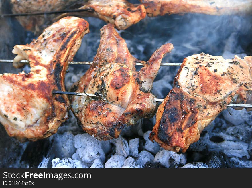 Barbecue with pork chops on the charcoal.