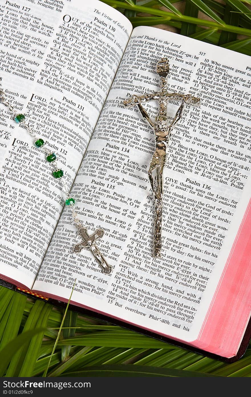 Close up of bible with rosary and crucifix with palm leaves. Close up of bible with rosary and crucifix with palm leaves