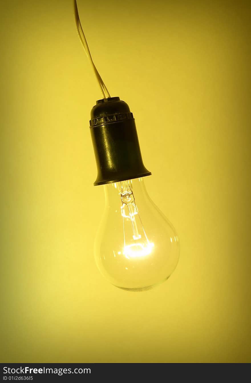 Photo of light bulb on yellow background