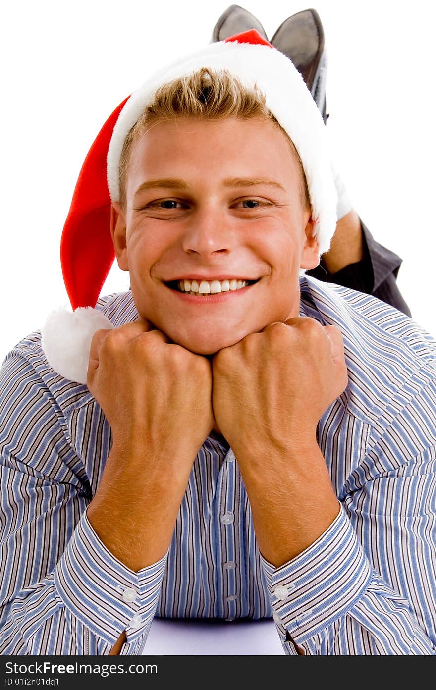 Happy laying man with christmas hat against white background