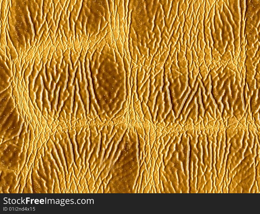 Unusual textural background from a yellow leather.