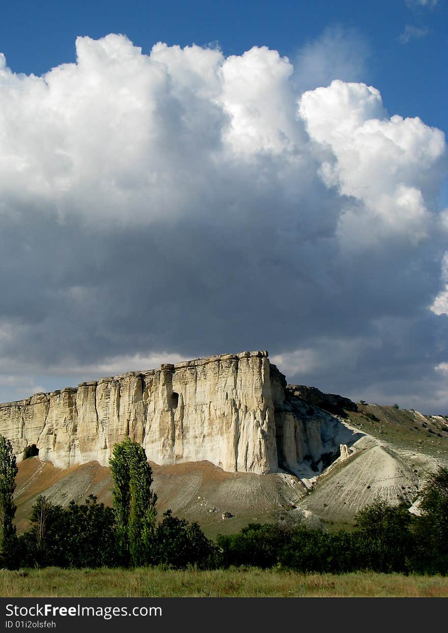 Mountainous landscape. Solitary cliff. Scenic cloud-drift. Mountainous landscape. Solitary cliff. Scenic cloud-drift.