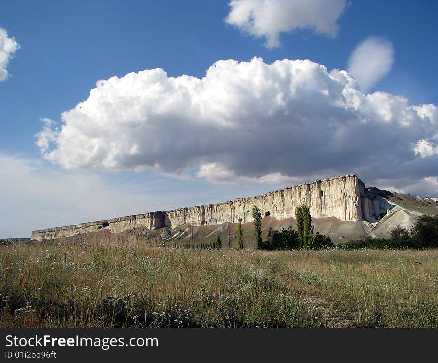 Mountainous landscape. Solitary cliff. Scenic cloud-drift. Mountainous landscape. Solitary cliff. Scenic cloud-drift.