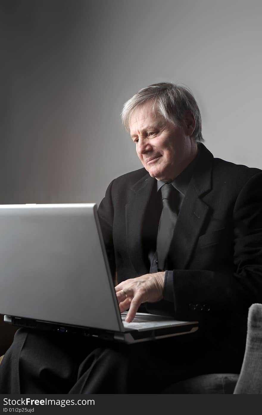 Senior businessman using a laptop