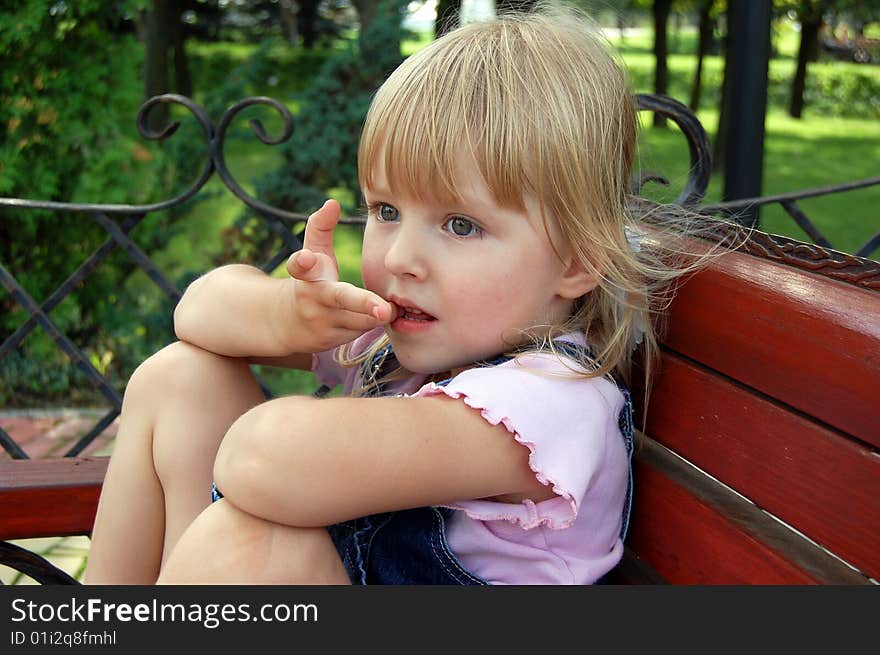 A little blond beautiful child (girl) gives a look of surprise. A little blond beautiful child (girl) gives a look of surprise