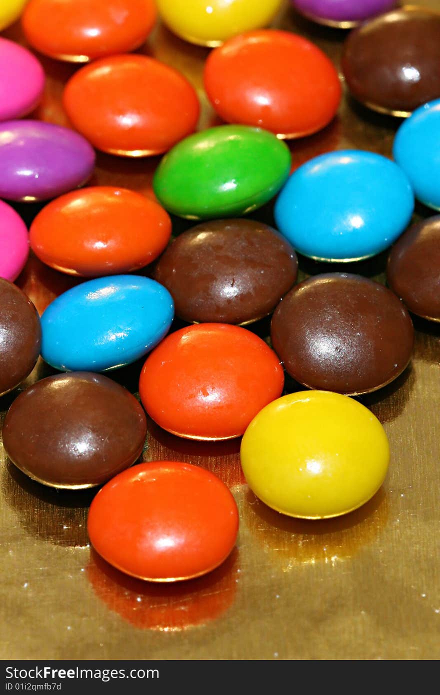 A pile of chocolate candies with a colorful outer shell