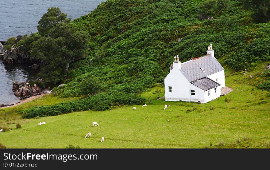 White isolated country house and green garden, scotland. White isolated country house and green garden, scotland