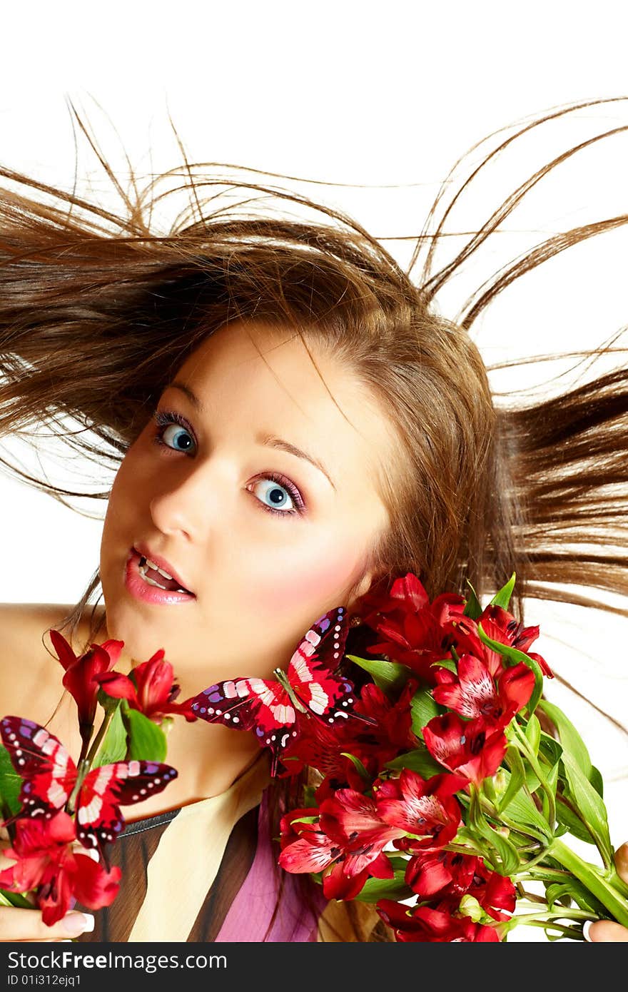 Attractive young woman with flowers, wind in hair. Attractive young woman with flowers, wind in hair