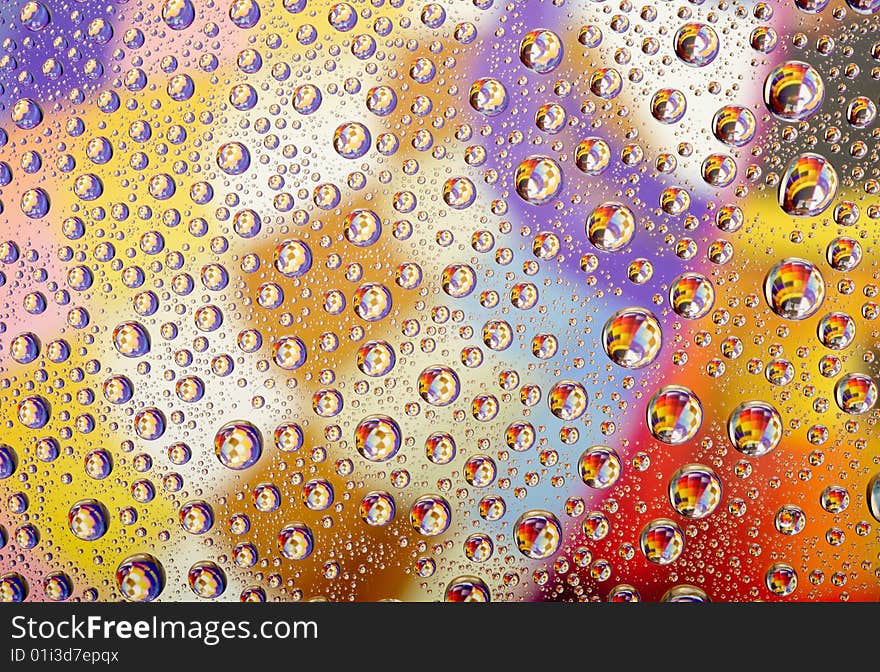 Coloured water drops on glass background. Coloured water drops on glass background