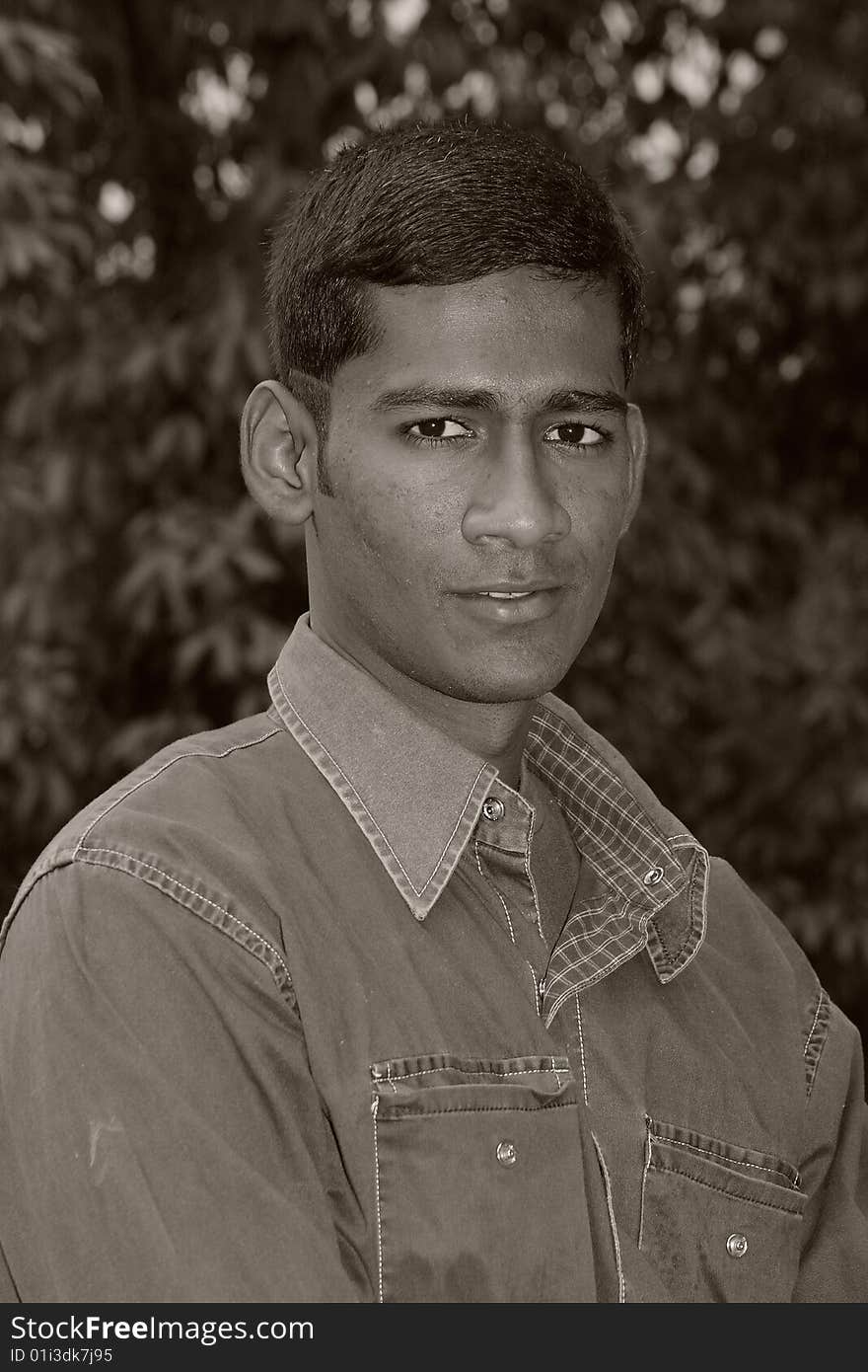 A young Indian man with sharp features.