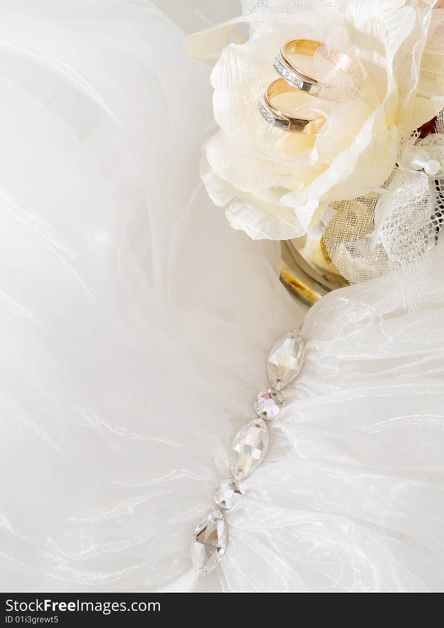 Closeup of wedding rings near decorative roses. Closeup of wedding rings near decorative roses