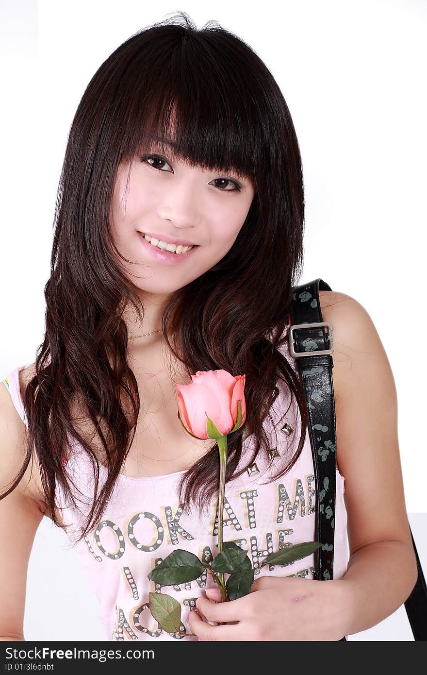 A beautiful Asian girl  holds a pink rose on white background. A beautiful Asian girl  holds a pink rose on white background.