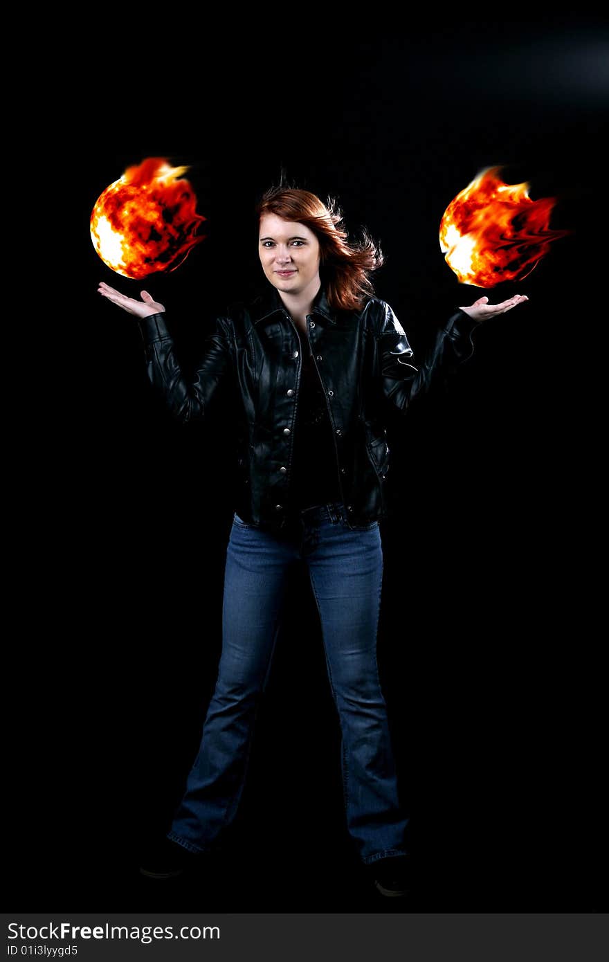 Teenage girl in black jacket holding floating fireballs in her hands. Teenage girl in black jacket holding floating fireballs in her hands