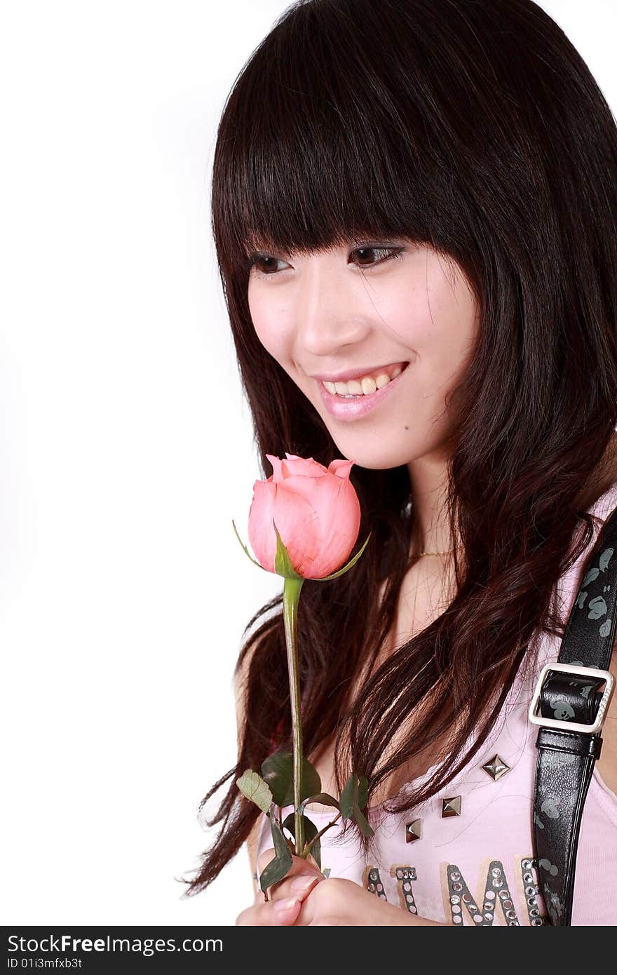 A beautiful Asian girl  holds a pink rose on white background. A beautiful Asian girl  holds a pink rose on white background.