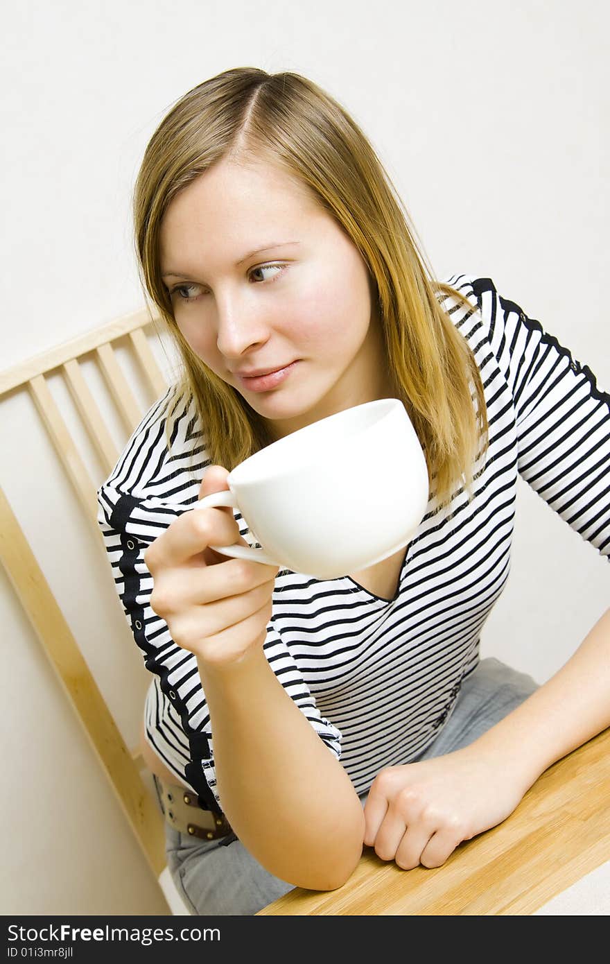 Beautiful girl holding a cup of coffee or tea. Beautiful girl holding a cup of coffee or tea