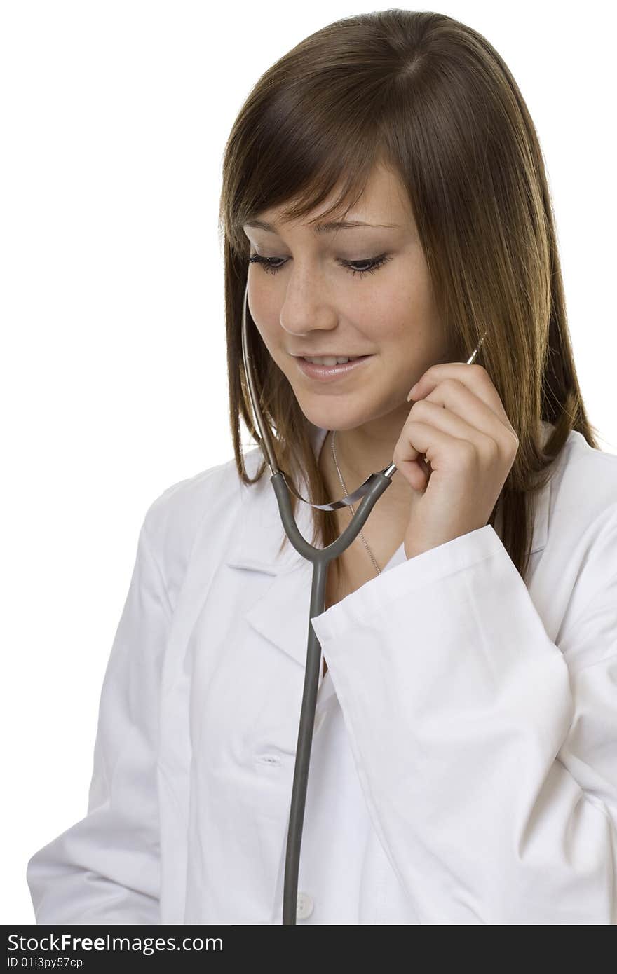 Young woman doctor with stethoscope, in a white coat against a white background